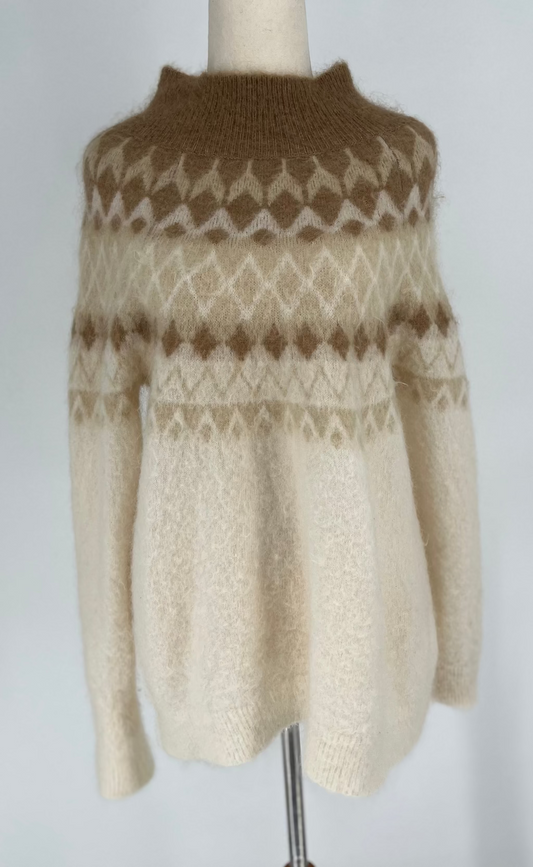 Knitted sweater with a pattern on a mannequin against a plain background