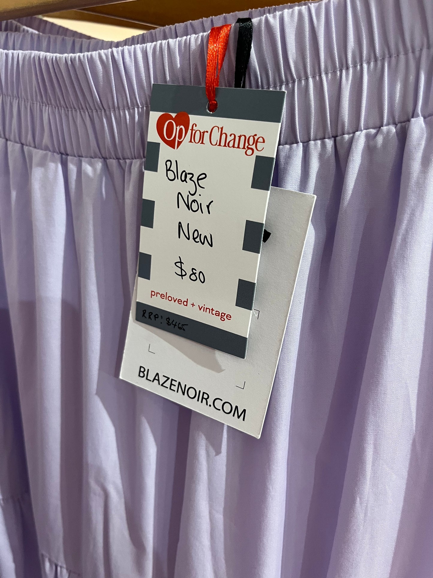 Clothing tag on a white garment with 'Blaz'n'ir' branding.