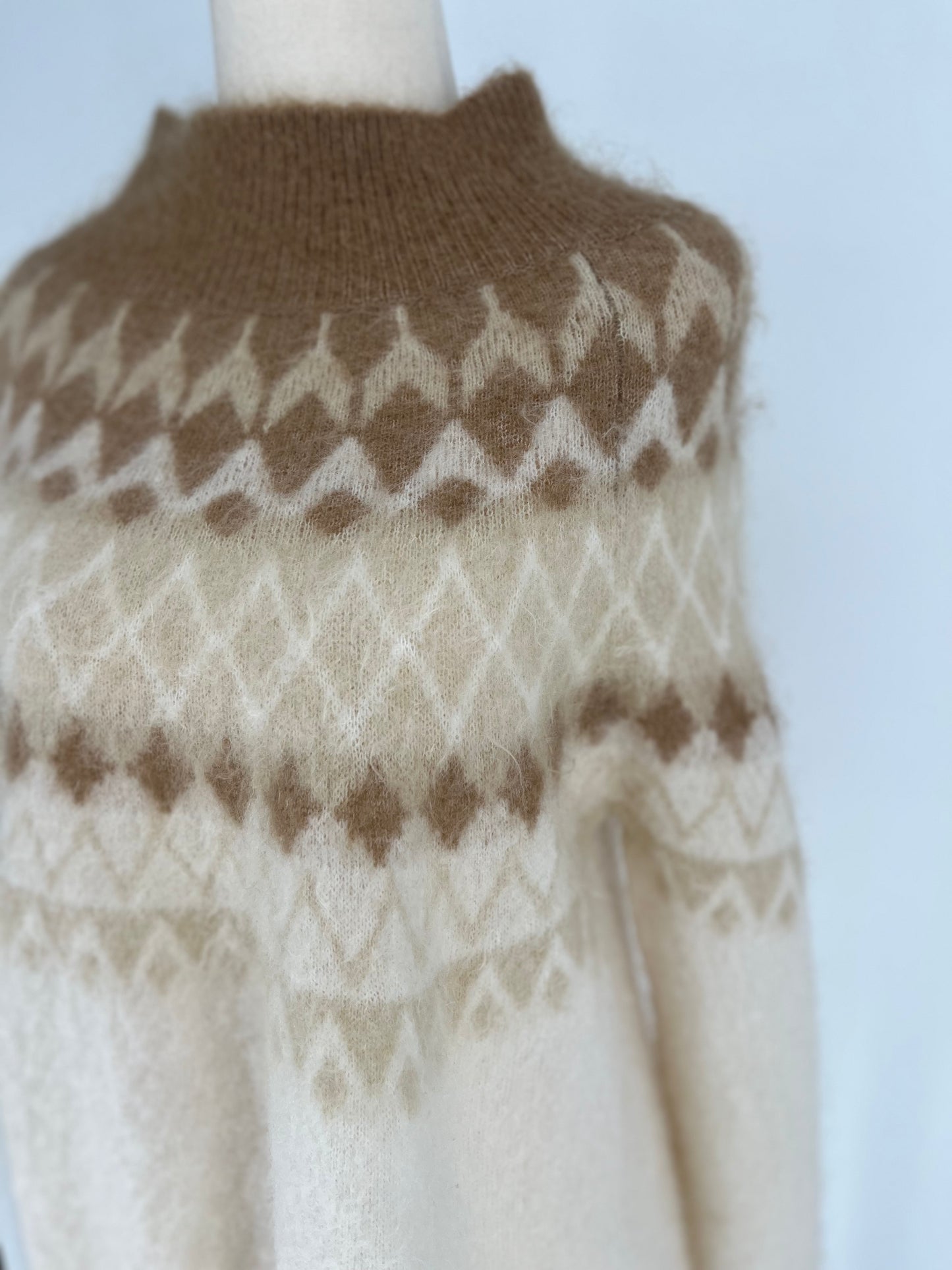 Knitted sweater with a pattern on a plain background