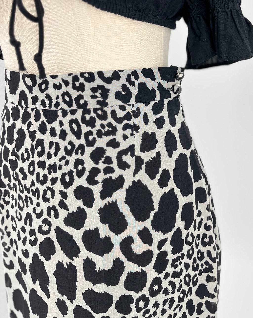 Leopard print skirt on a mannequin with a white background
