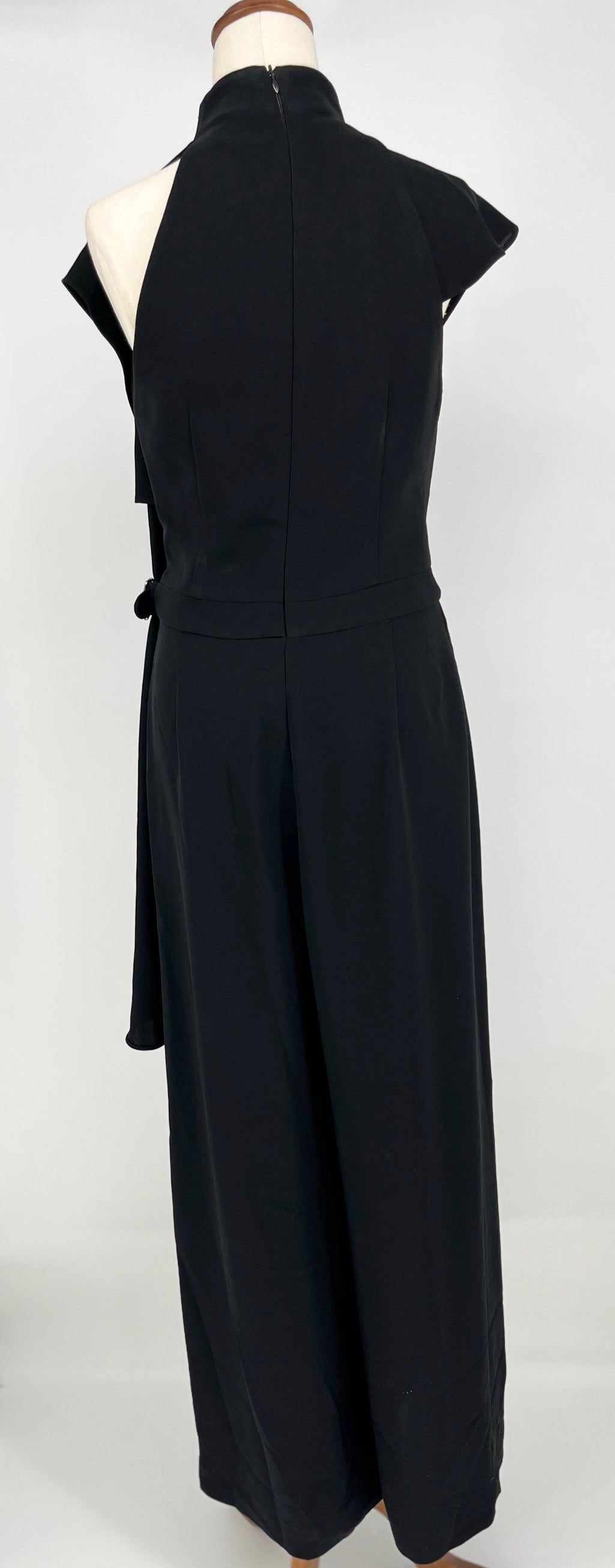 Black jumpsuit on a mannequin against a white background