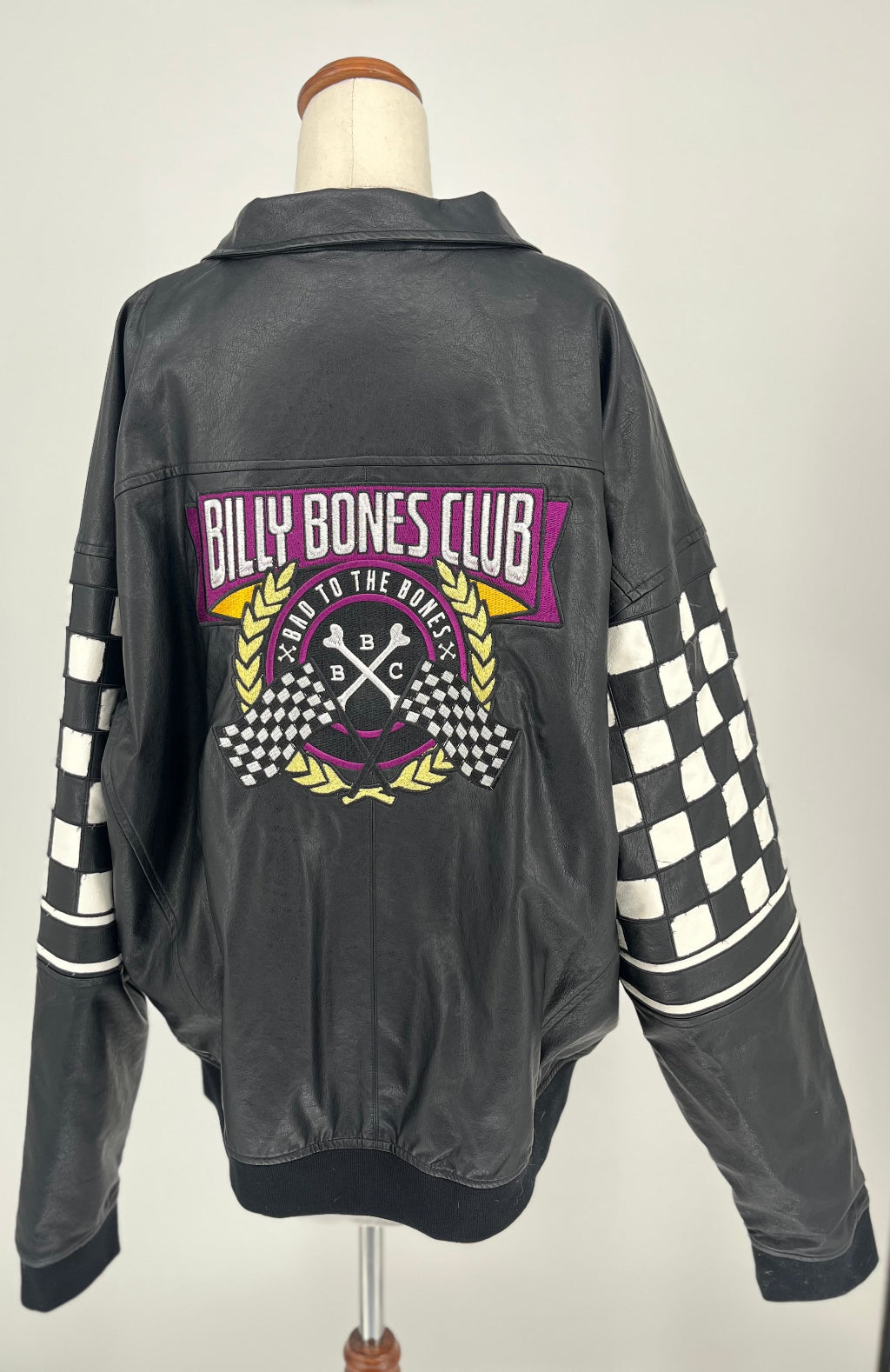 Black jacket with 'Billy Bones Club' logo on a mannequin against a white background