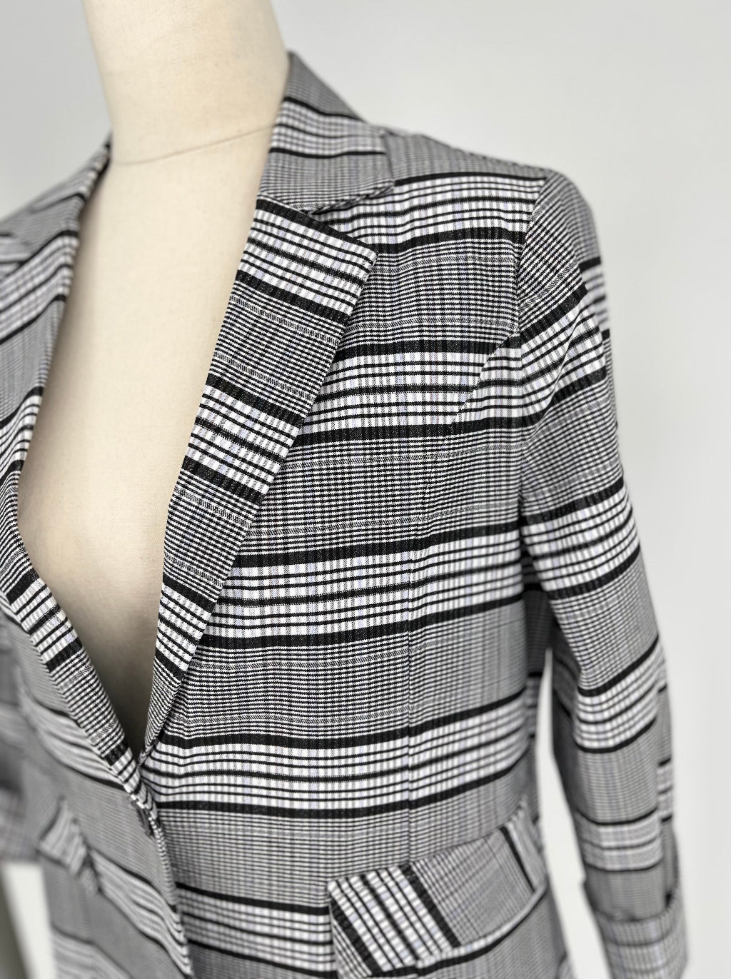 black and white checked jacket on mannequin