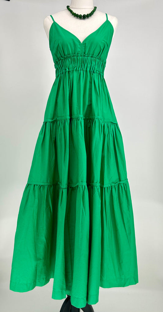 Green tiered dress on a mannequin against a gray background