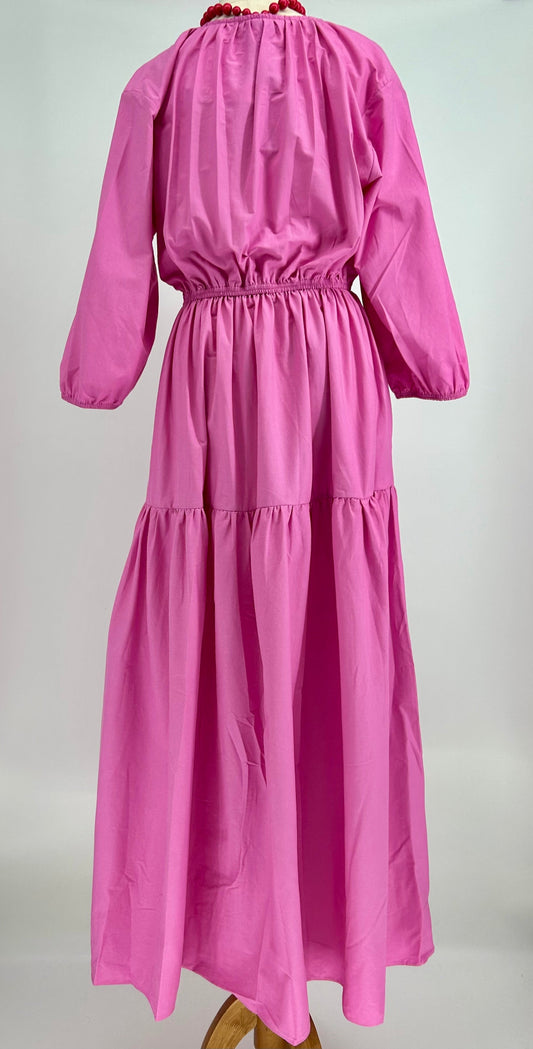 Pink dress with long sleeves on a grey background