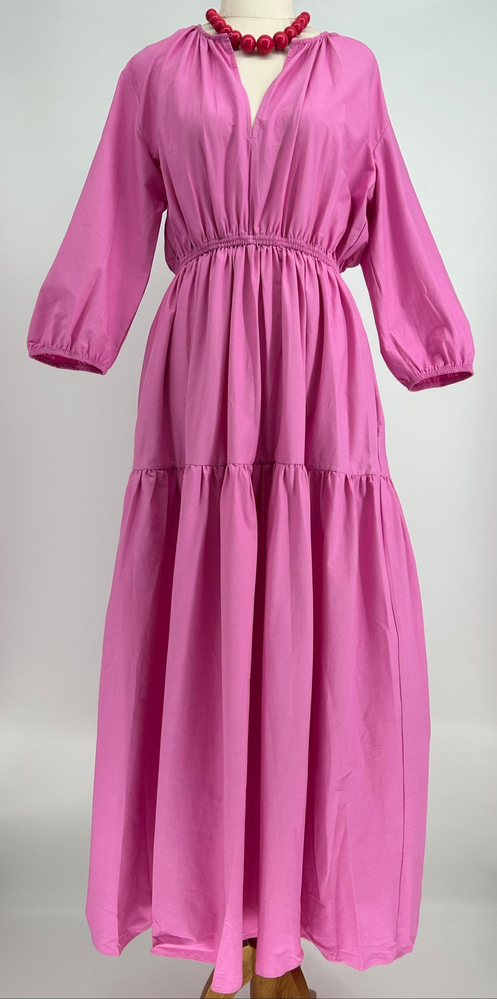 Pink dress with long sleeves on a white background