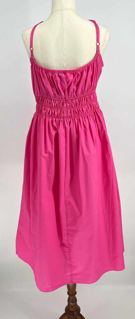 Pink dress on a mannequin against a white background