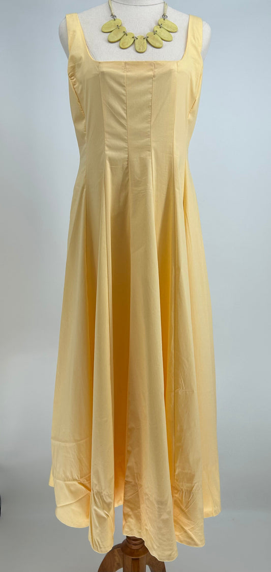 Yellow dress on a mannequin against a white background