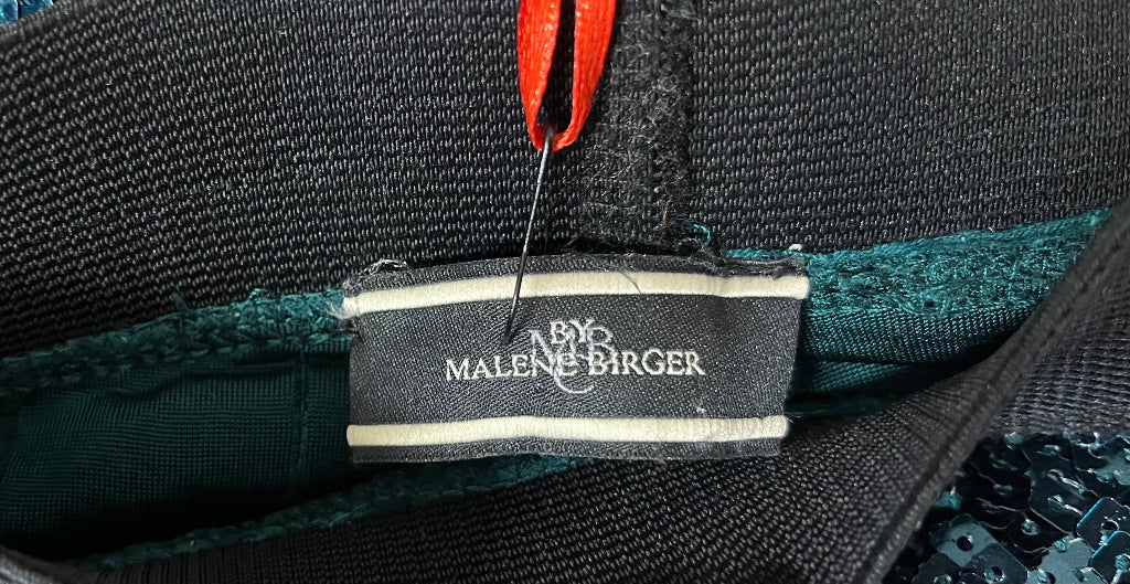 Close-up of a label on a product with 'By Malene Birger' branding.