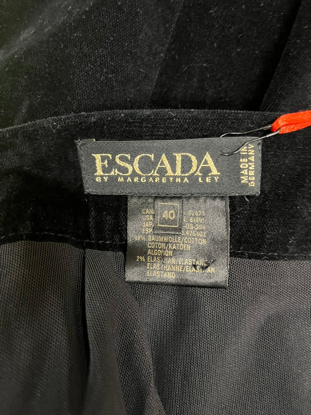 Escada label on a black fabric background