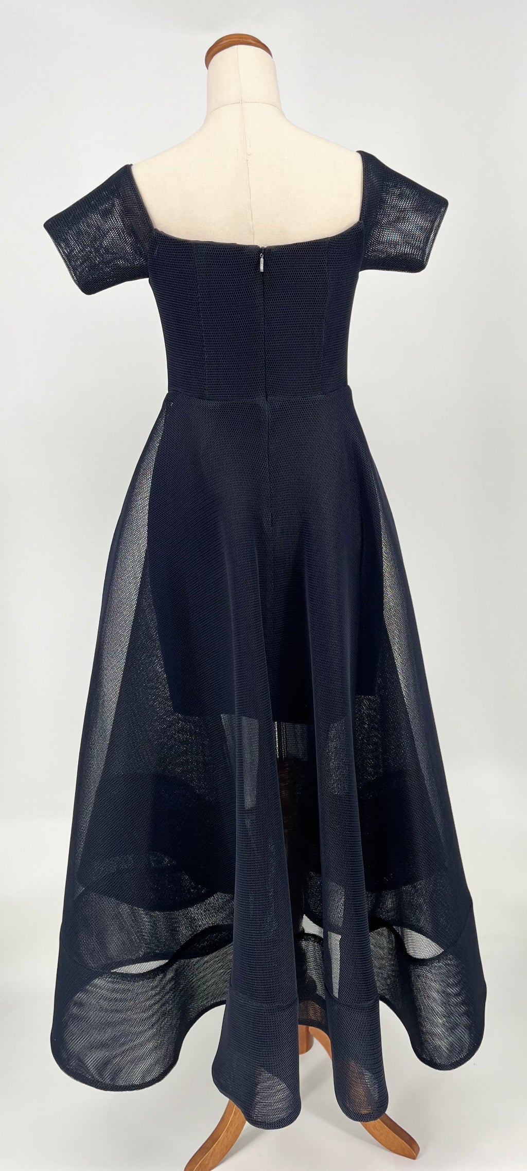 Navy blue dress on a mannequin against a white background