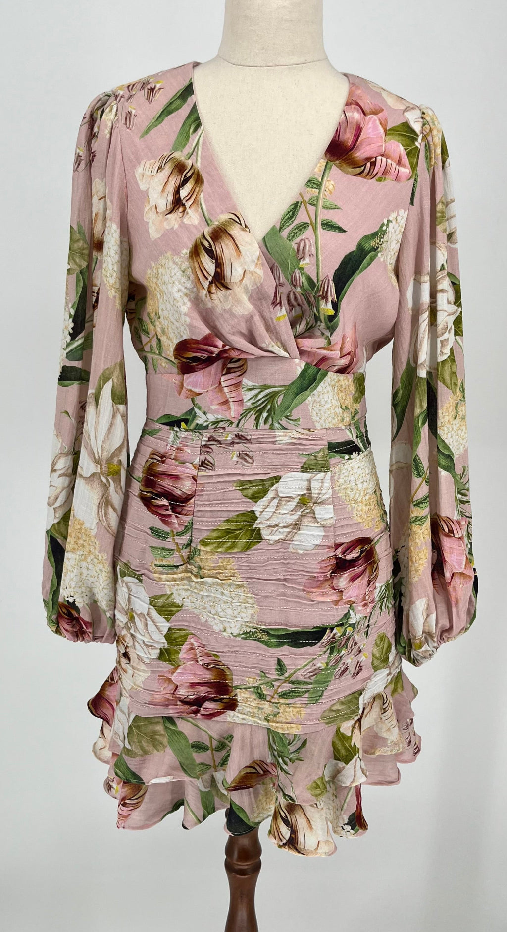 Floral dress on a mannequin against a plain background