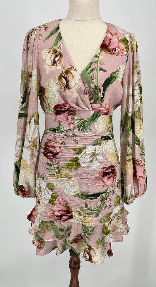 Floral dress on a mannequin against a plain background