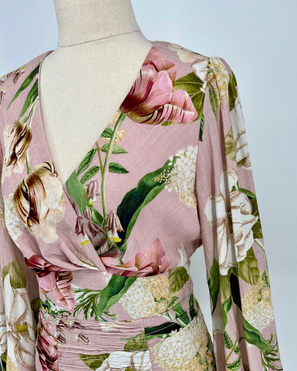 Floral patterned fabric on a mannequin with a plain background