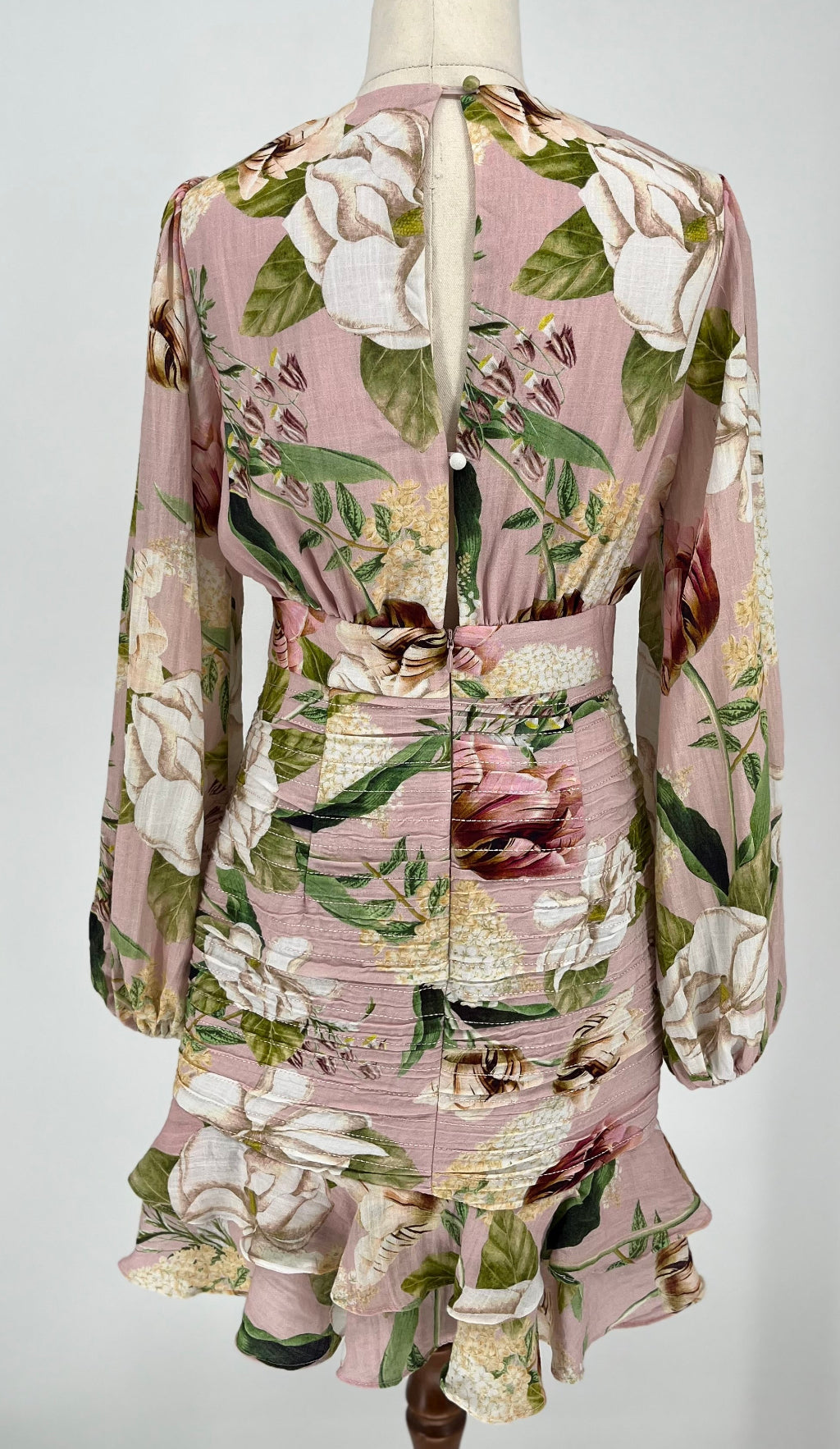 Floral dress on a mannequin against a white background