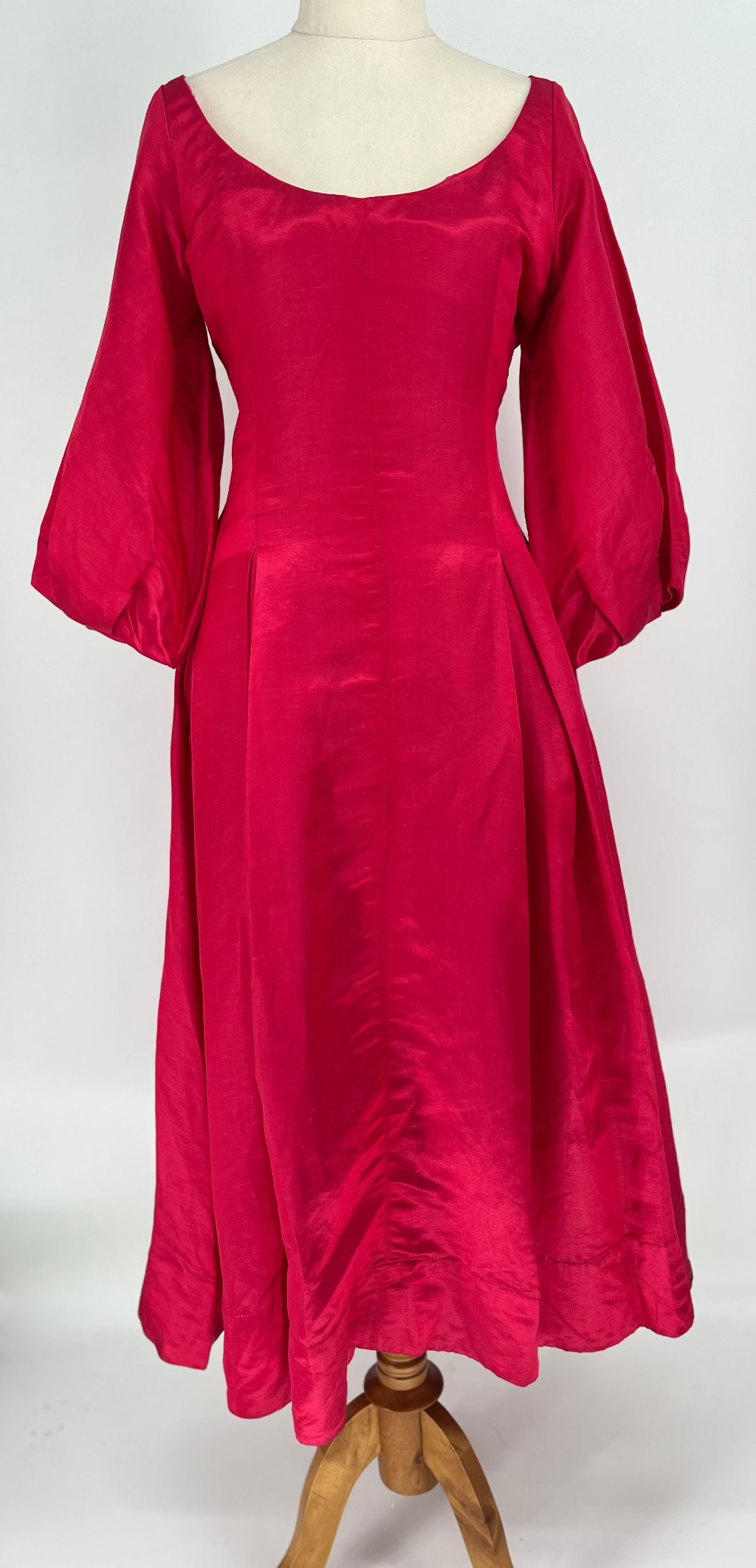 Red dress on a mannequin against a white background