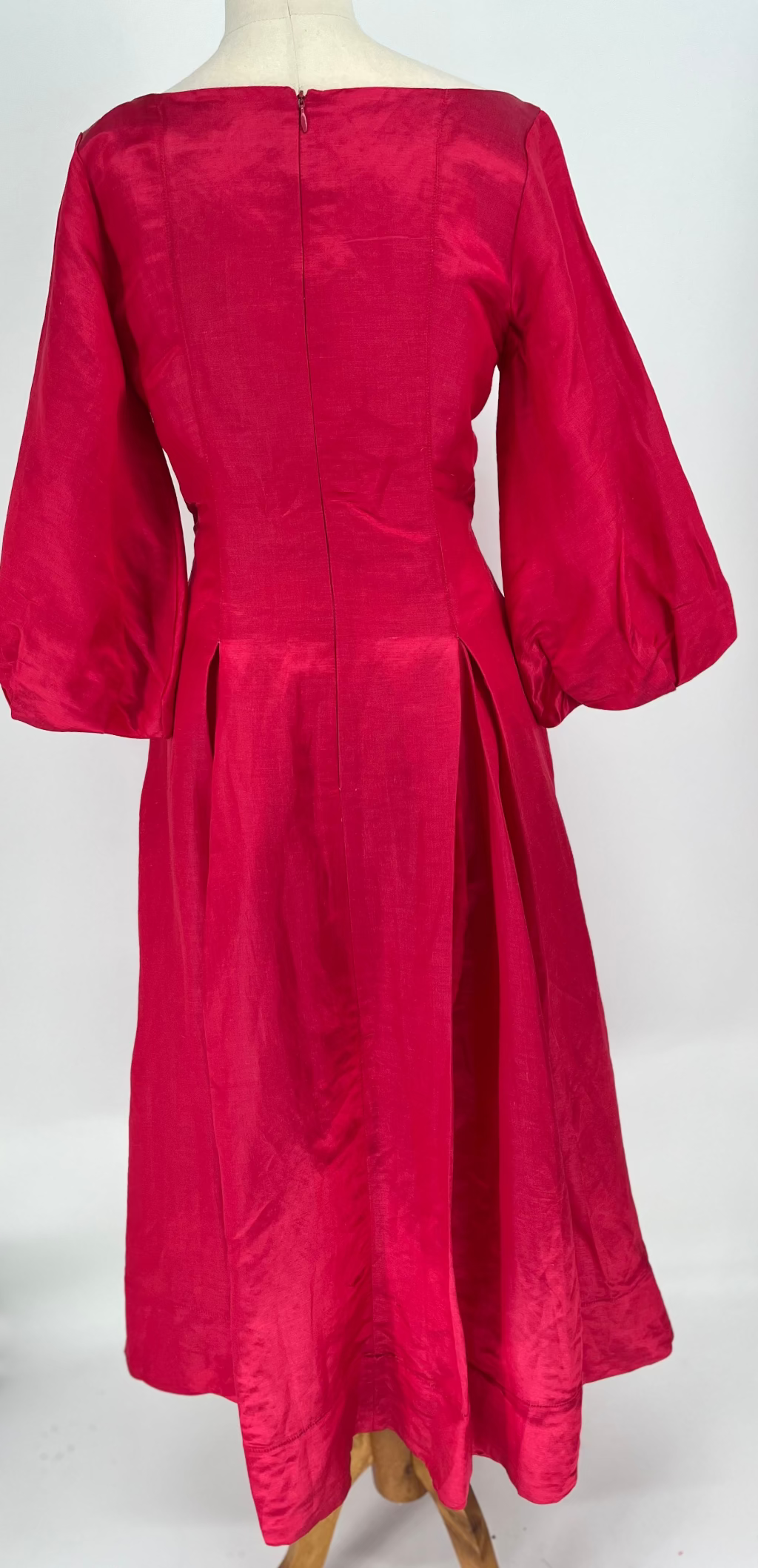 Red dress on a mannequin against a white background