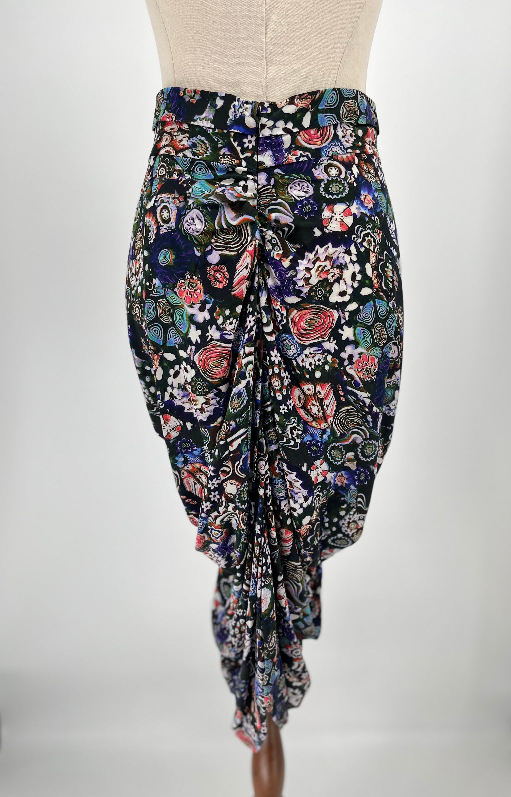 Floral patterned skirt on a mannequin against a white background