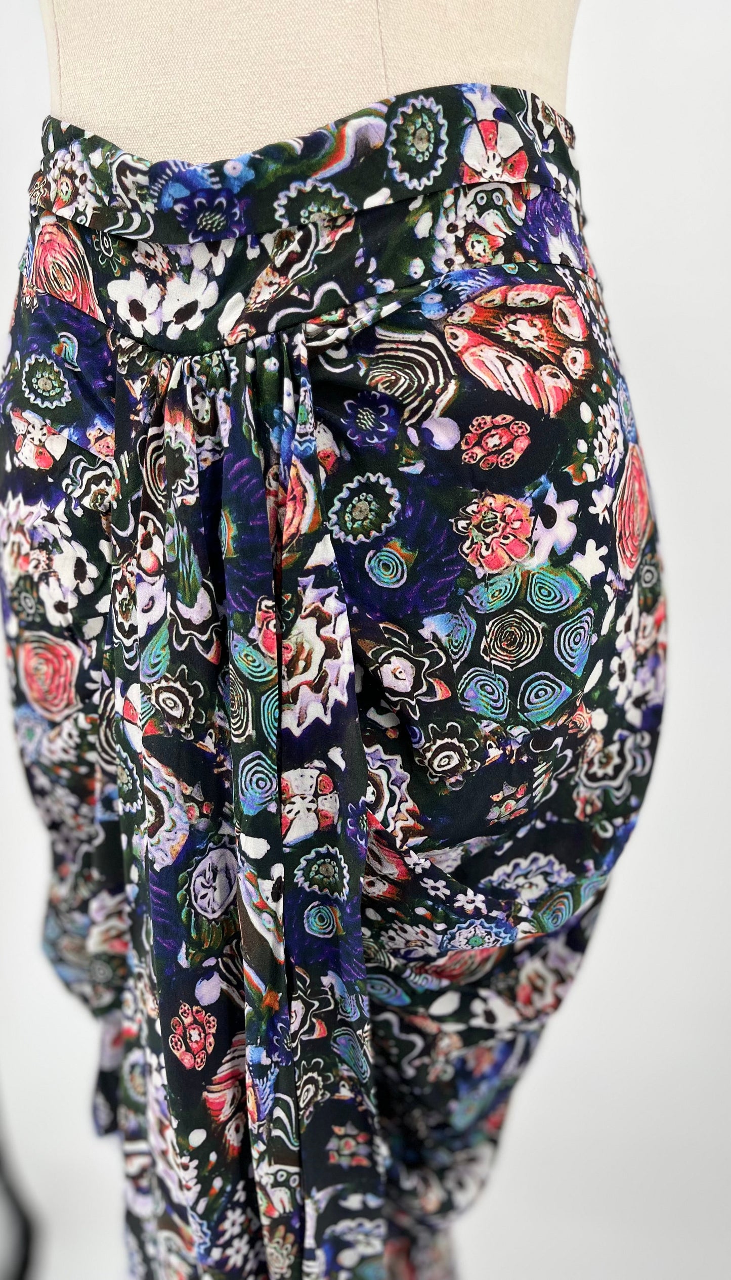 Colorful patterned pants on a mannequin against a white background