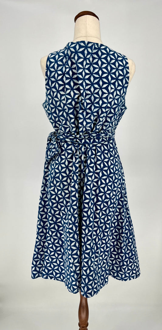 Blue and white patterned dress on a mannequin against a white background