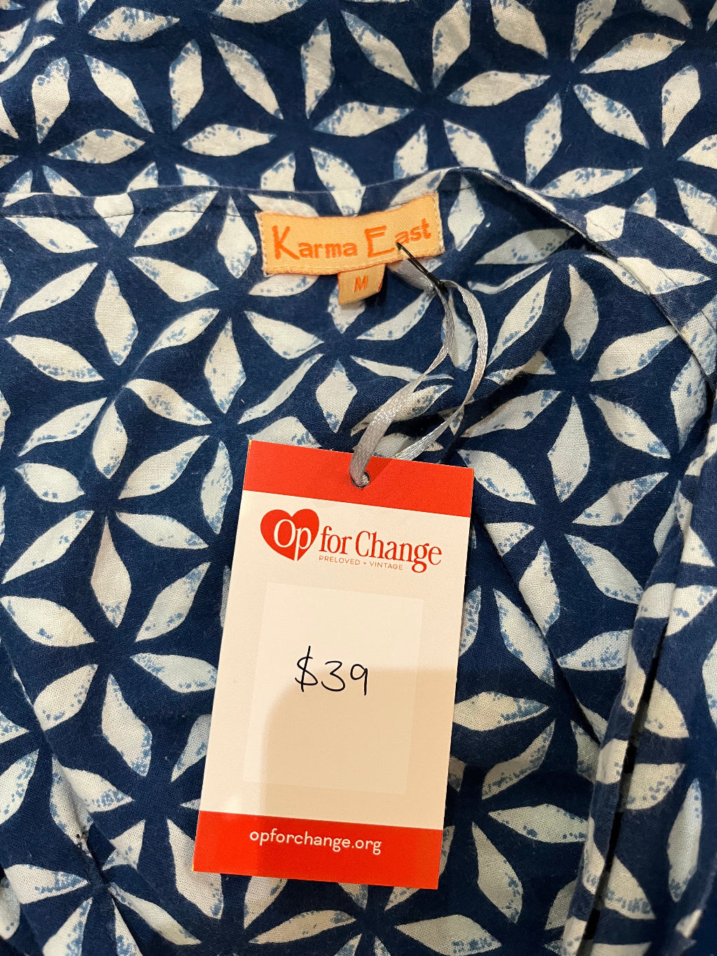 Navy fabric with white pattern and a 'Op for Change' tag on a matching background