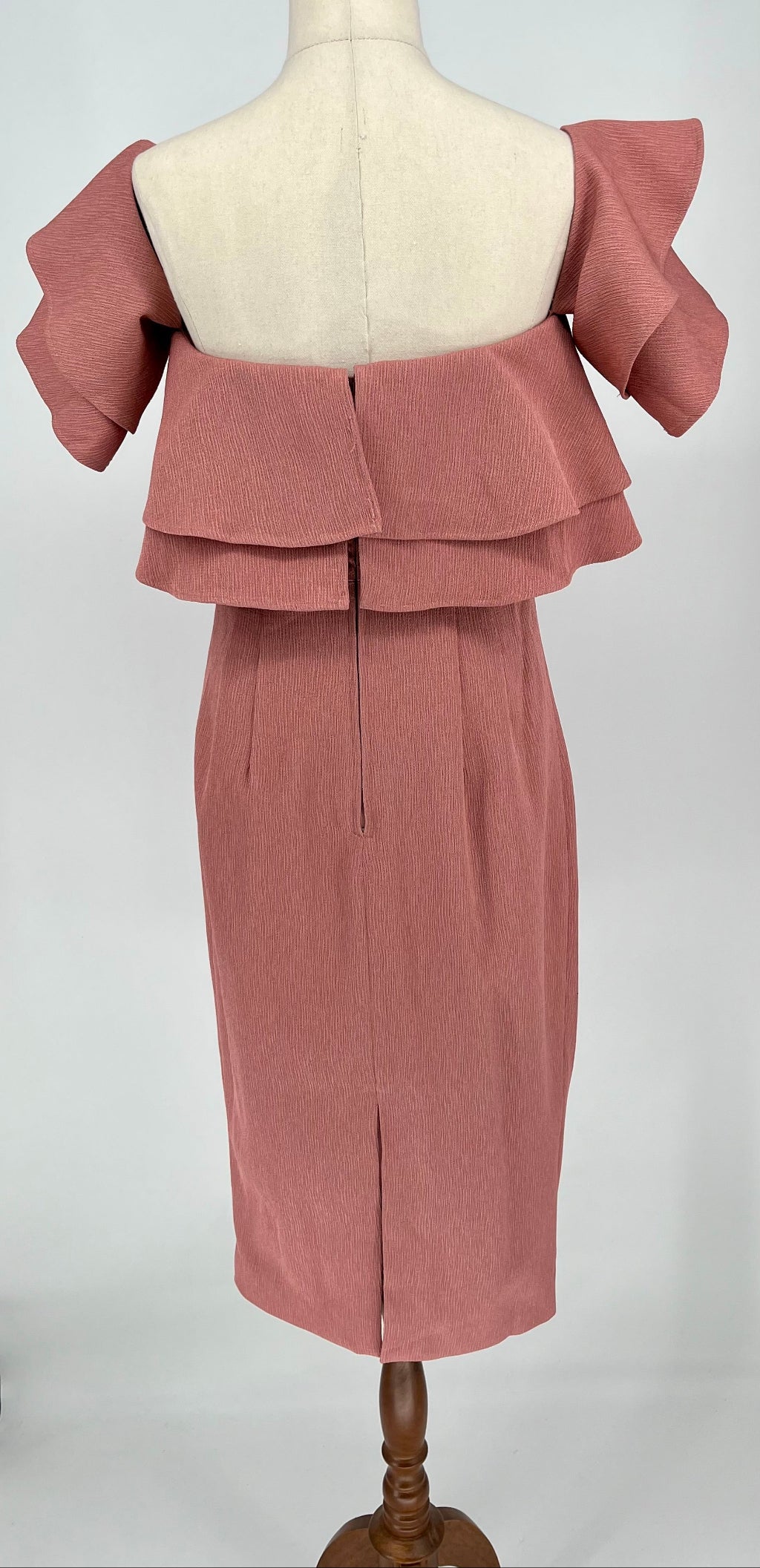 Pink dress  on a mannequin against a white background