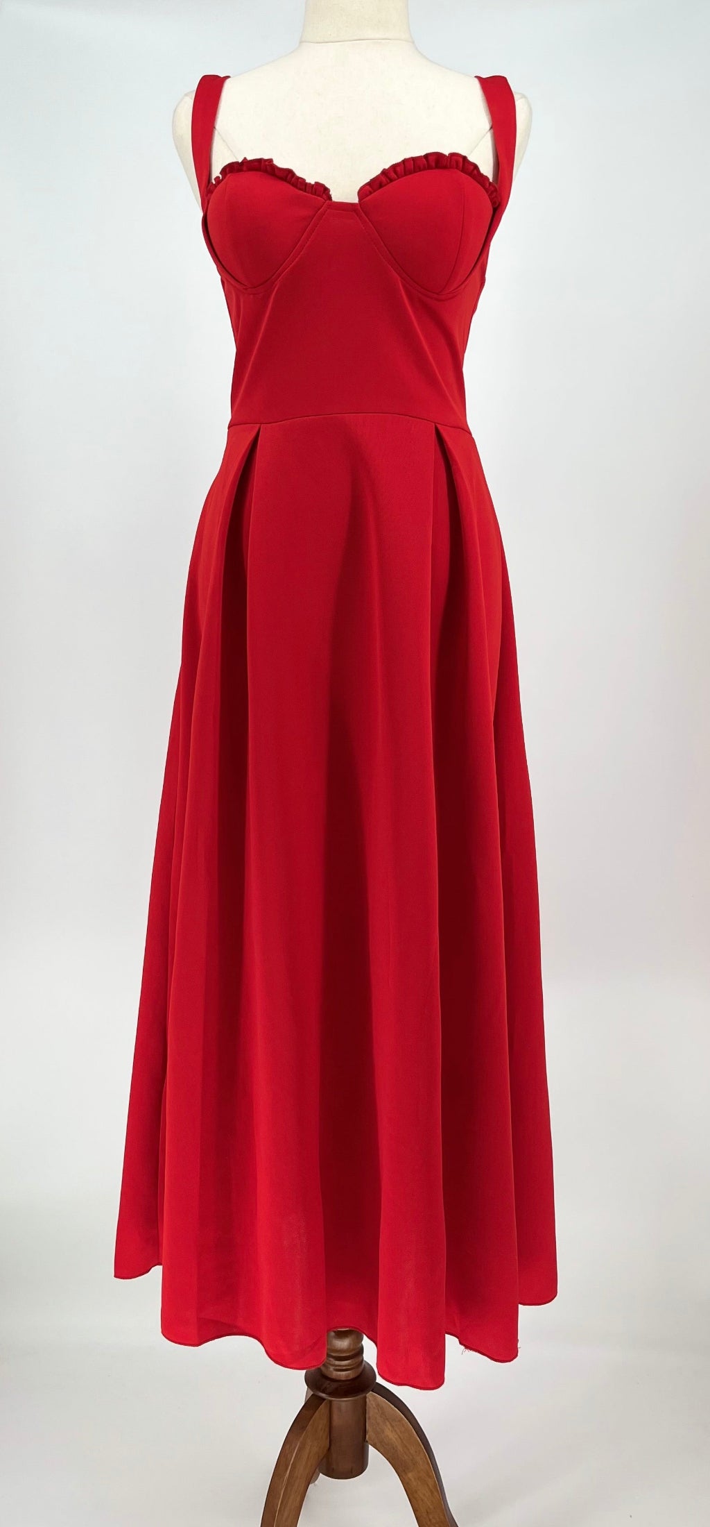 Red dress on a mannequin against a white background