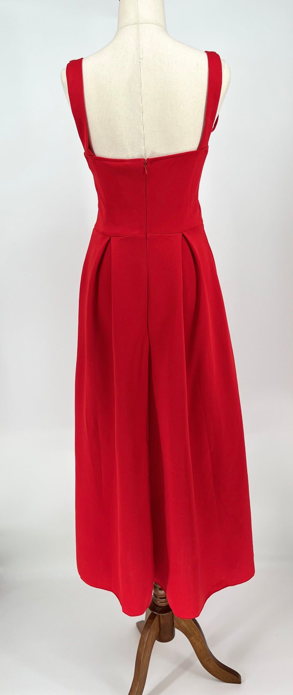 Red dress on a mannequin against a white background