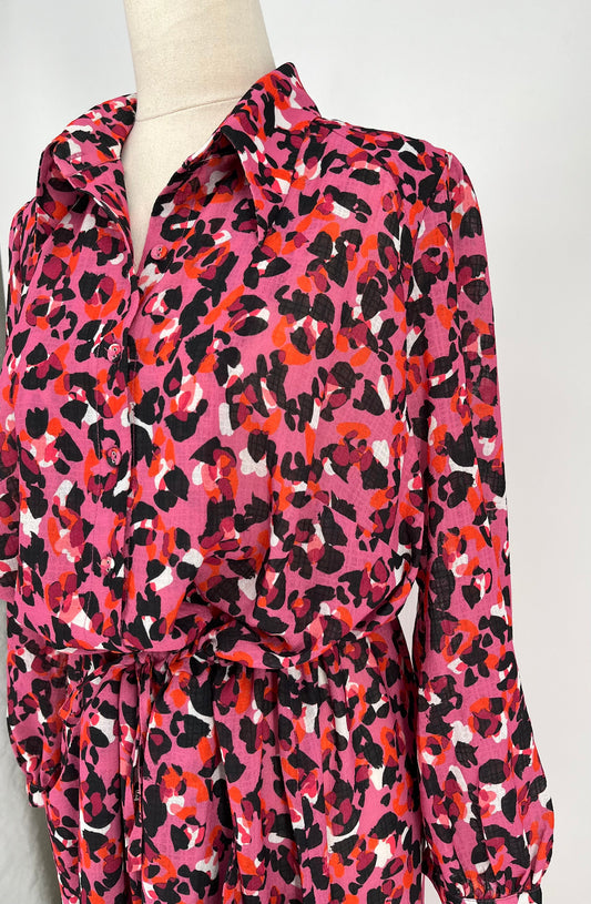 Mannequin wearing a pink and orange leopard print dress against a white background