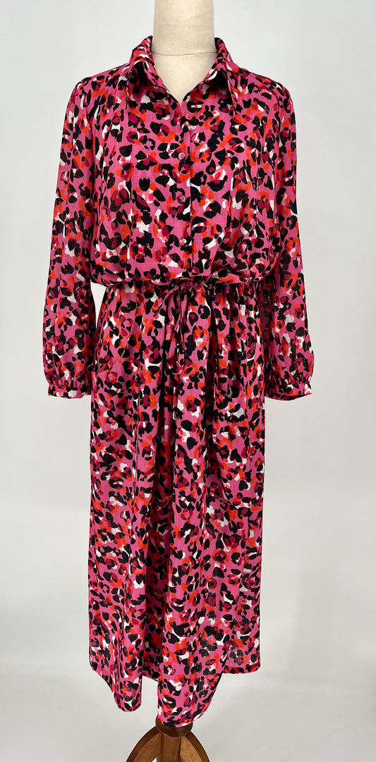 Pink leopard print dress on a mannequin against a white background