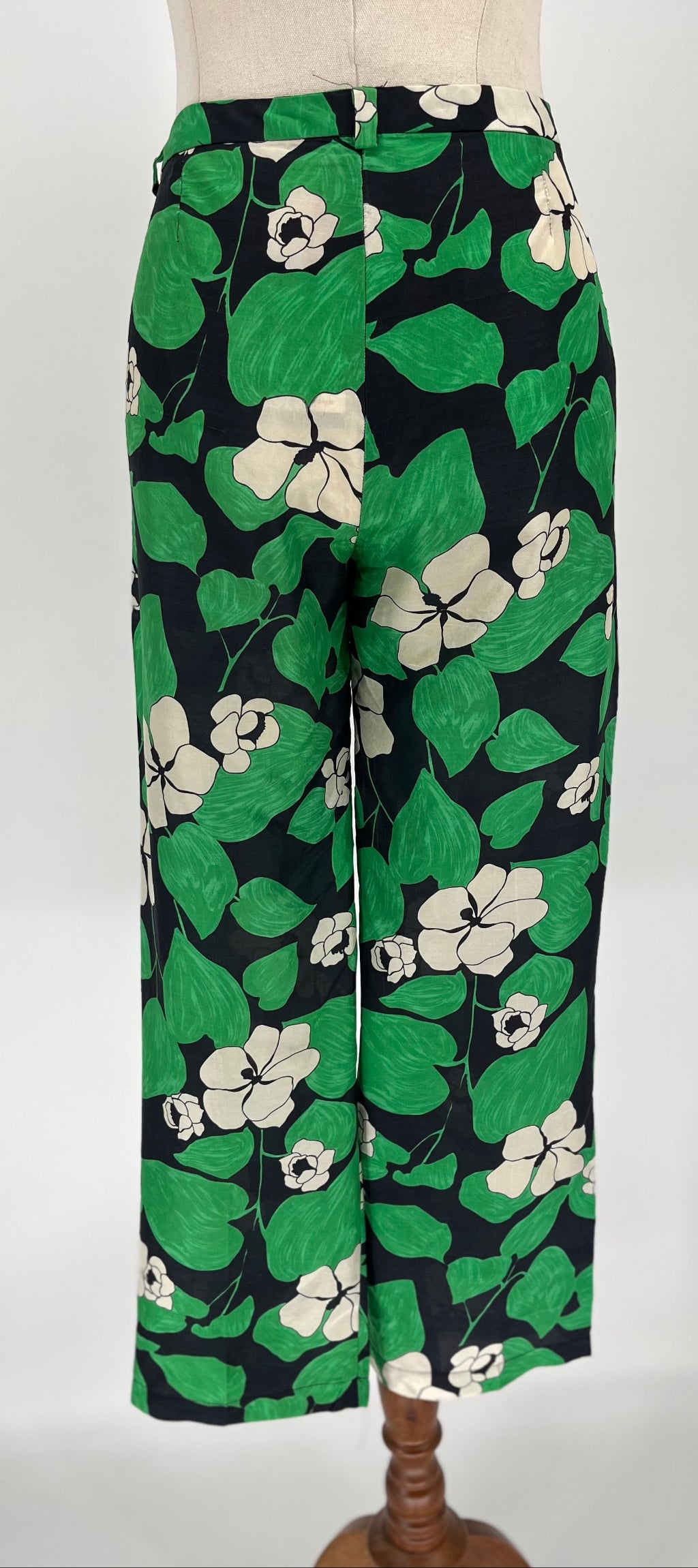 Floral-patterned pants on a mannequin against a white background