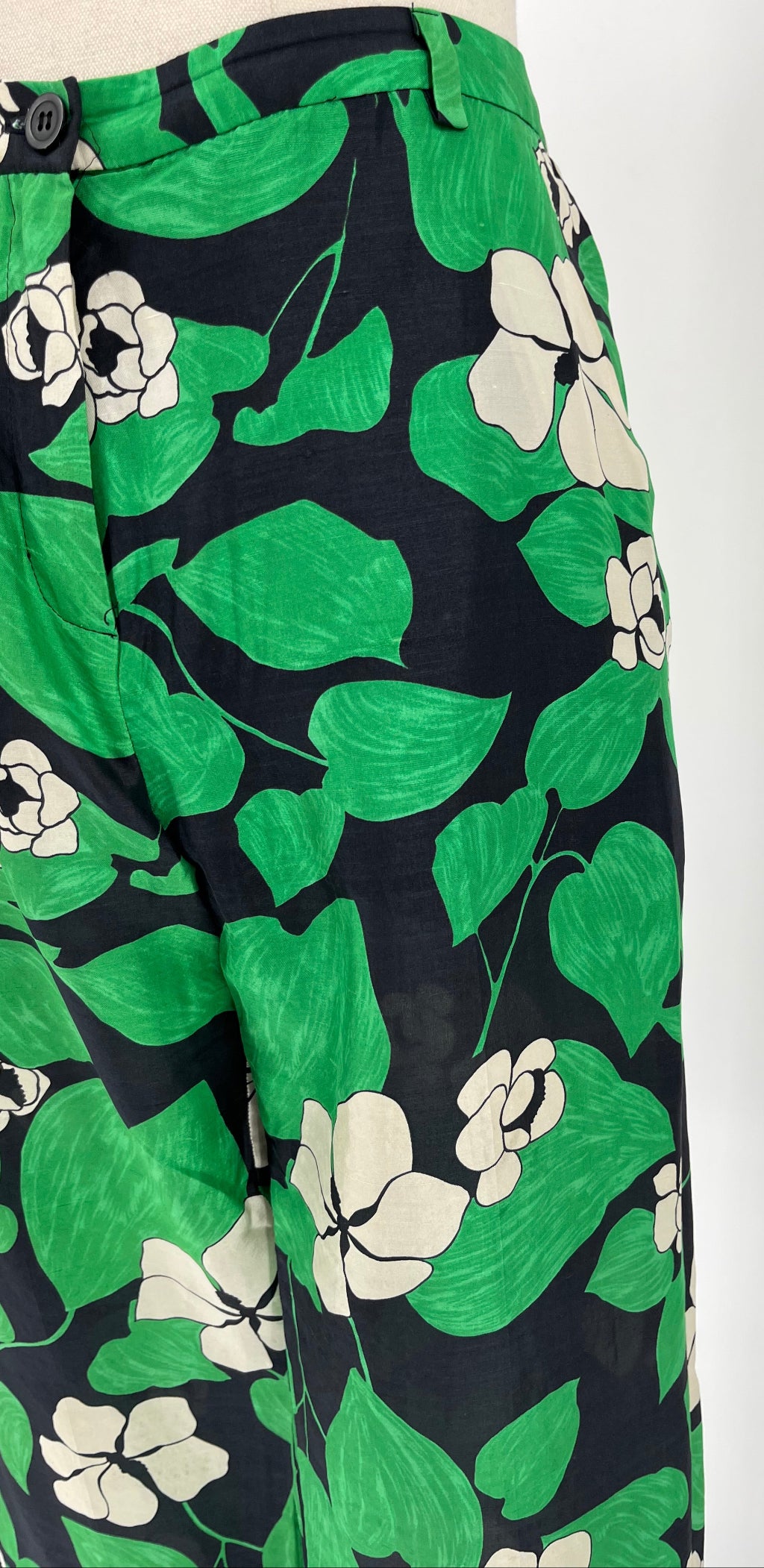 Green floral patterned fabric on a white background