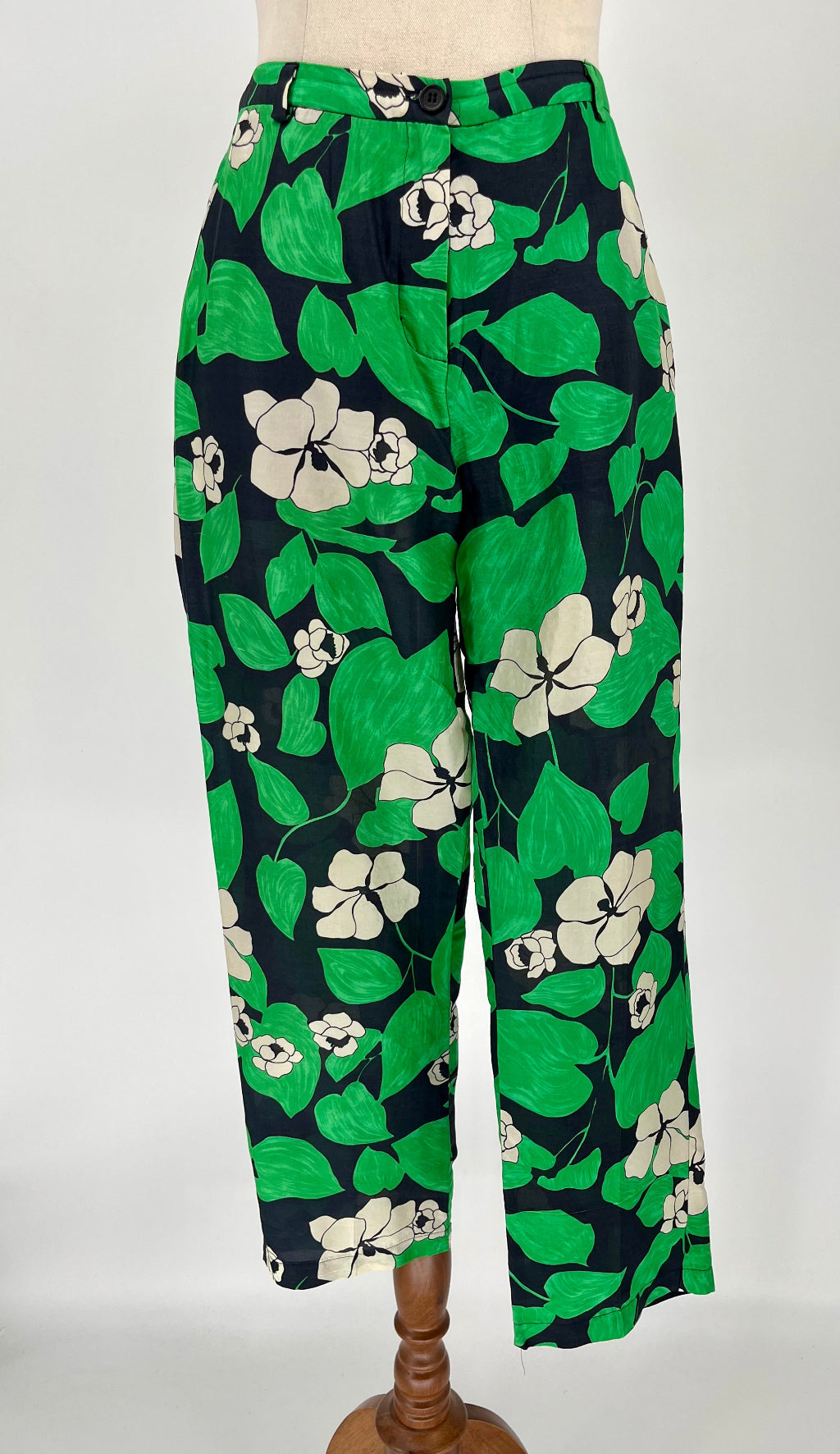 Floral-patterned pants on a mannequin against a white background