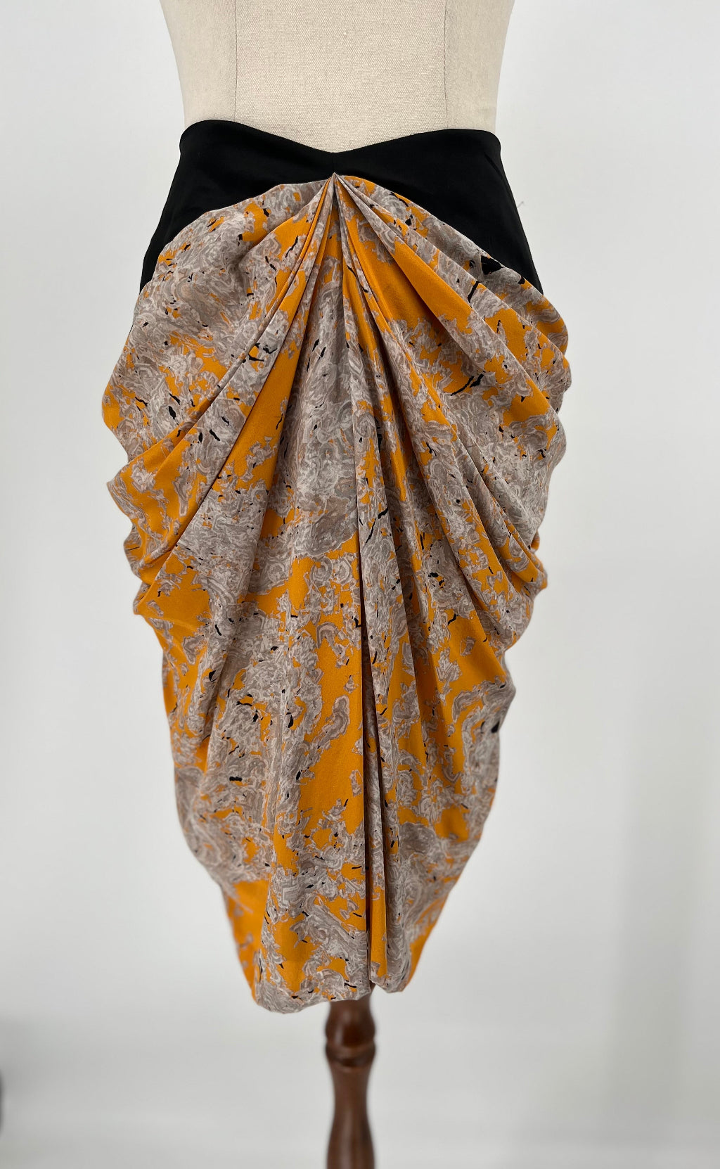 Skirt with yellow and gray pattern on a mannequin against a white background