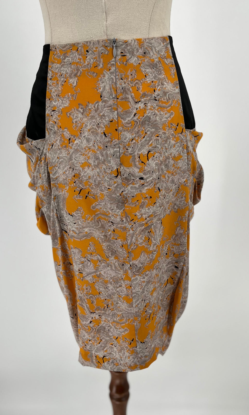 Skirt with yellow and gray pattern on a mannequin against a white background
