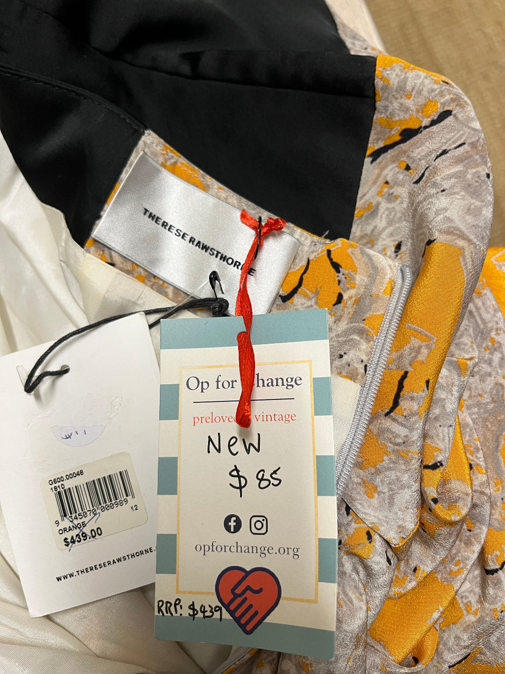Clothing with tags and labels on a neutral background