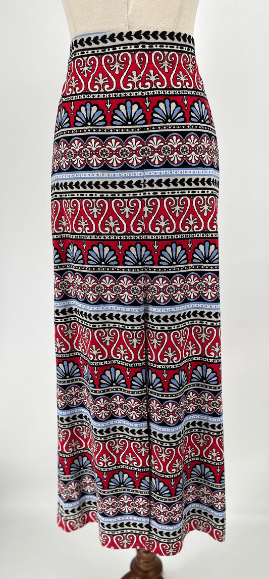 Patterned skirt with red, black, and white design on a mannequin against a white background
