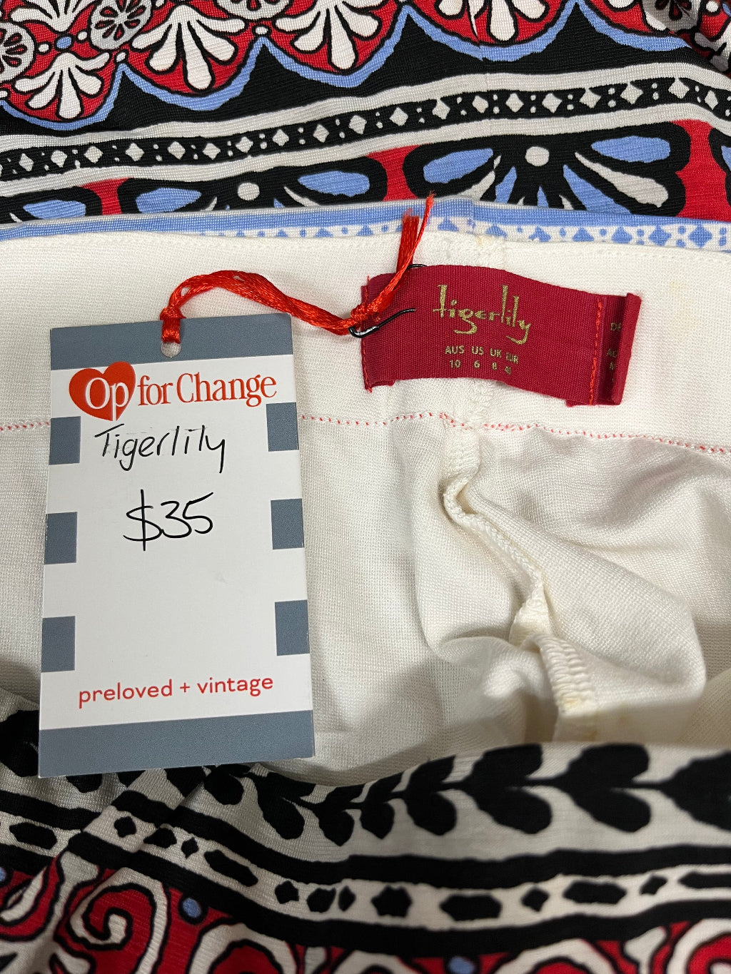 Tigerlily tag on a patterned background