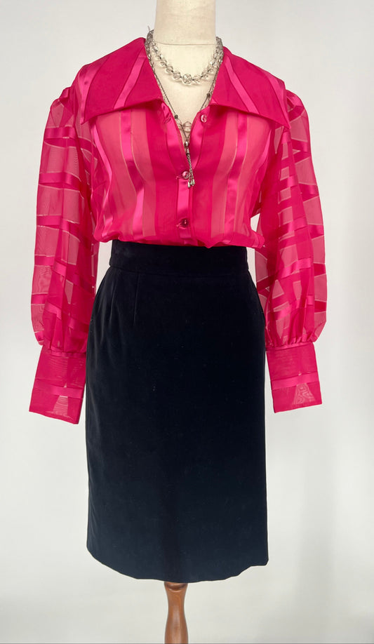 Mannequin wearing a pink striped blouse and black skirt on a white background