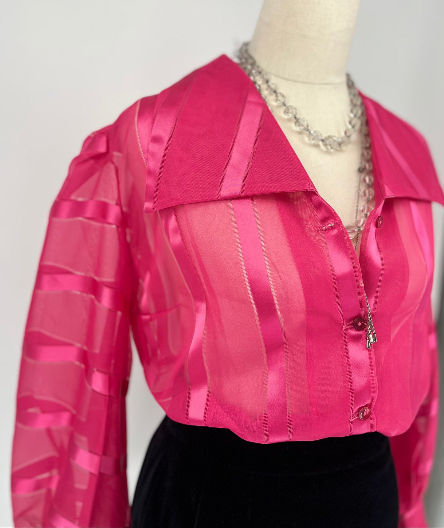 Pink blouse on a mannequin with a white background