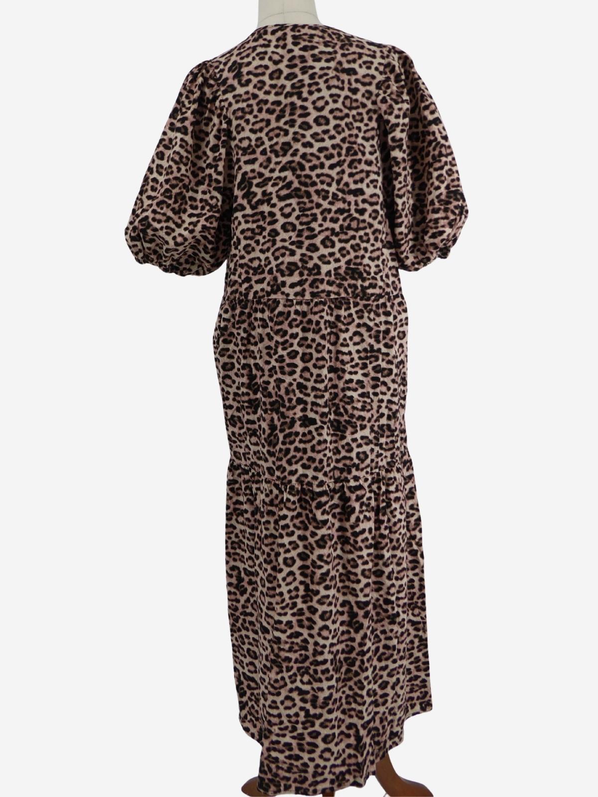 Back view of a long-sleeve Decjuba midi dress with an animal print design, displayed on a mannequin against a white studio background.