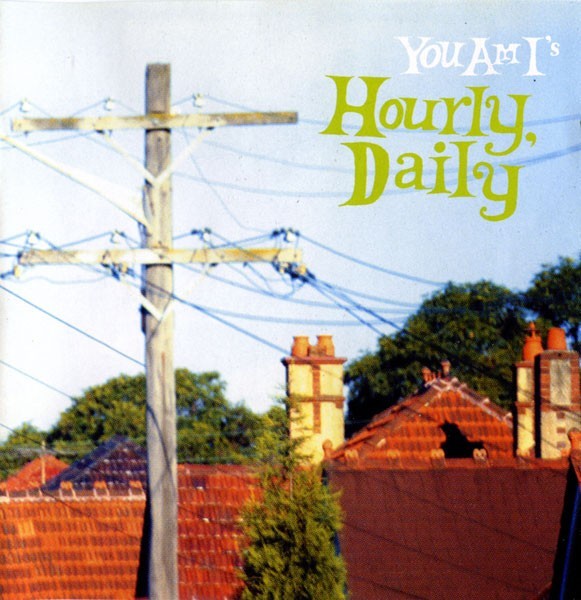 Music CD cover with power lines and buildings, featuring text 'You Am I's Hourly, Daily'.